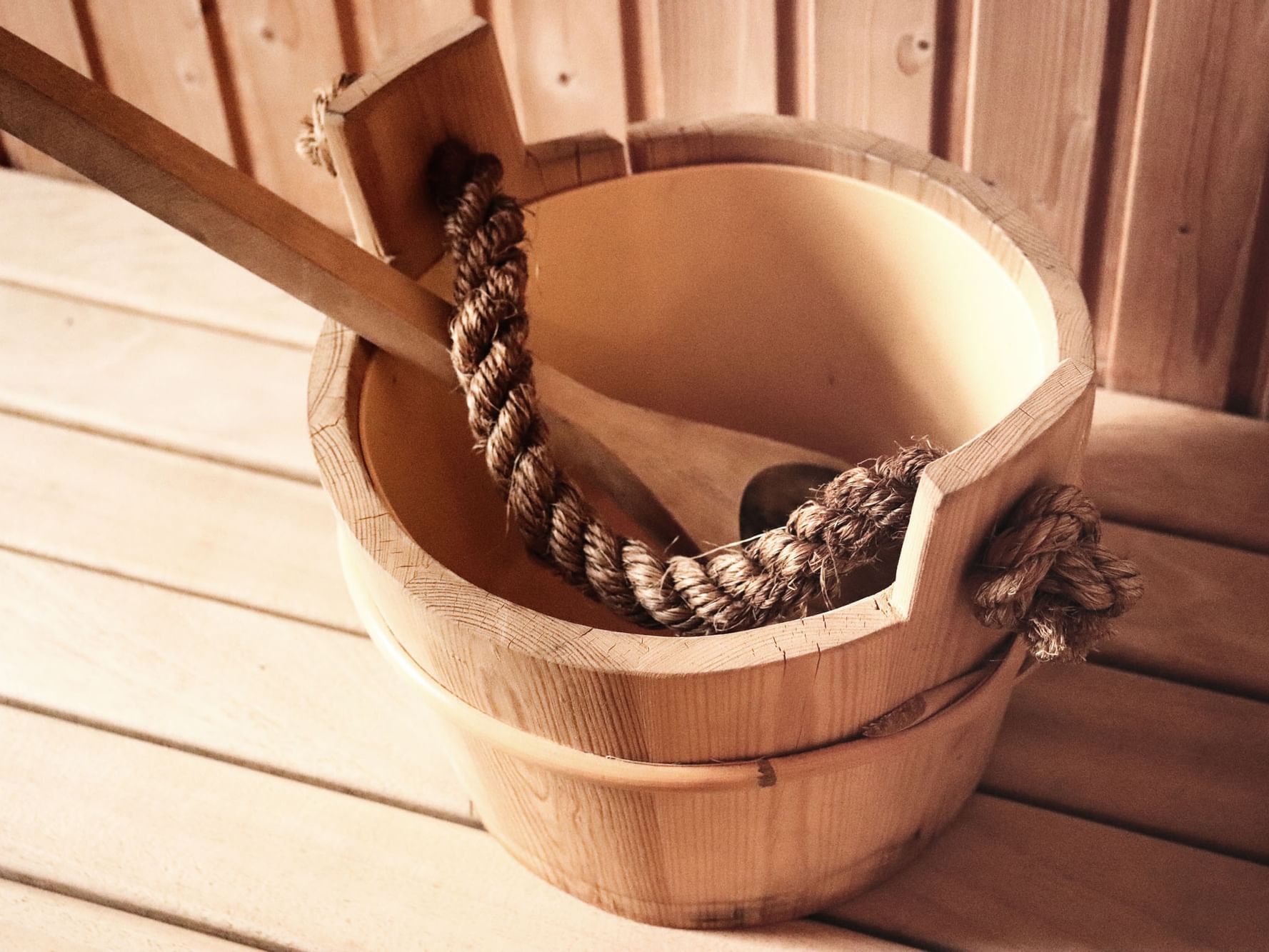 Water bucket with a spoon in the sauna at VE Hotel & Residence