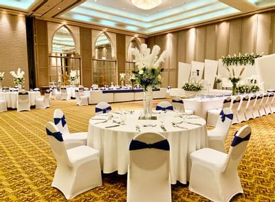 Floral décor on tables arranged for a wedding at Ajman Hotel