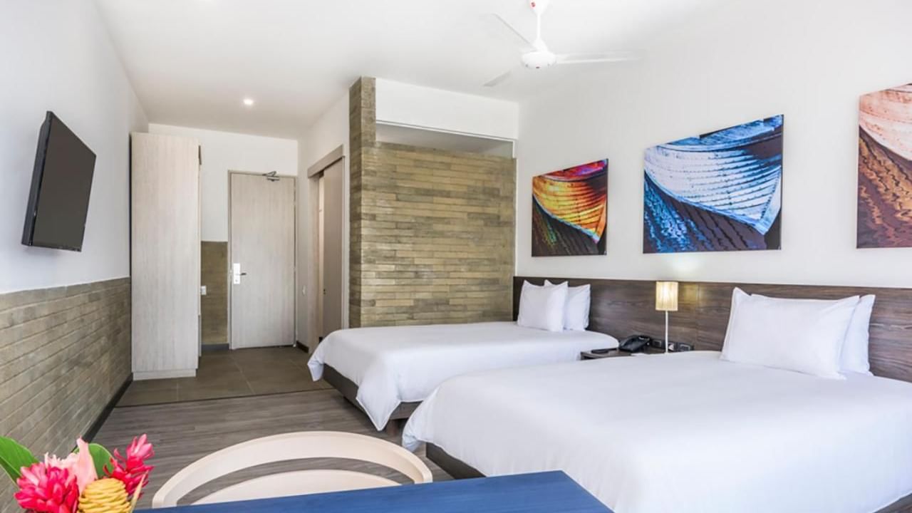 Pop twin room with Twin beds, TV & dining table at DOT Hotels