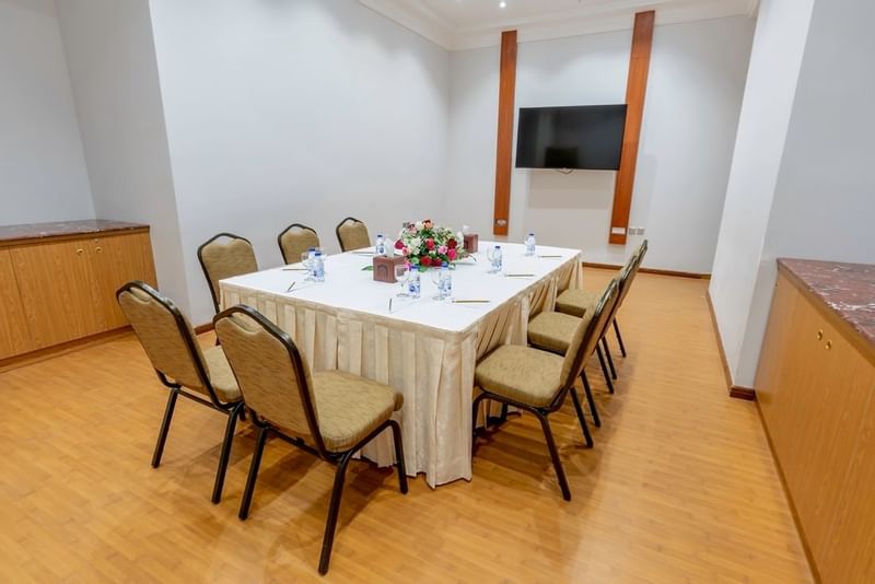 Boardroom table set-up with TV in Narcissus Room at Makeen Homes by Warwick - Riyadh