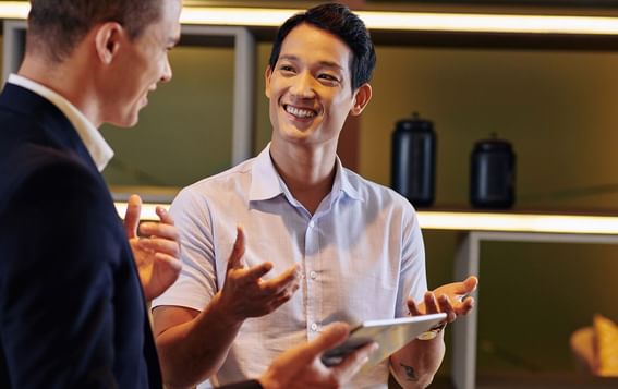 Two concierges engaging in a conversation at LK Resort Bandungan Semarang