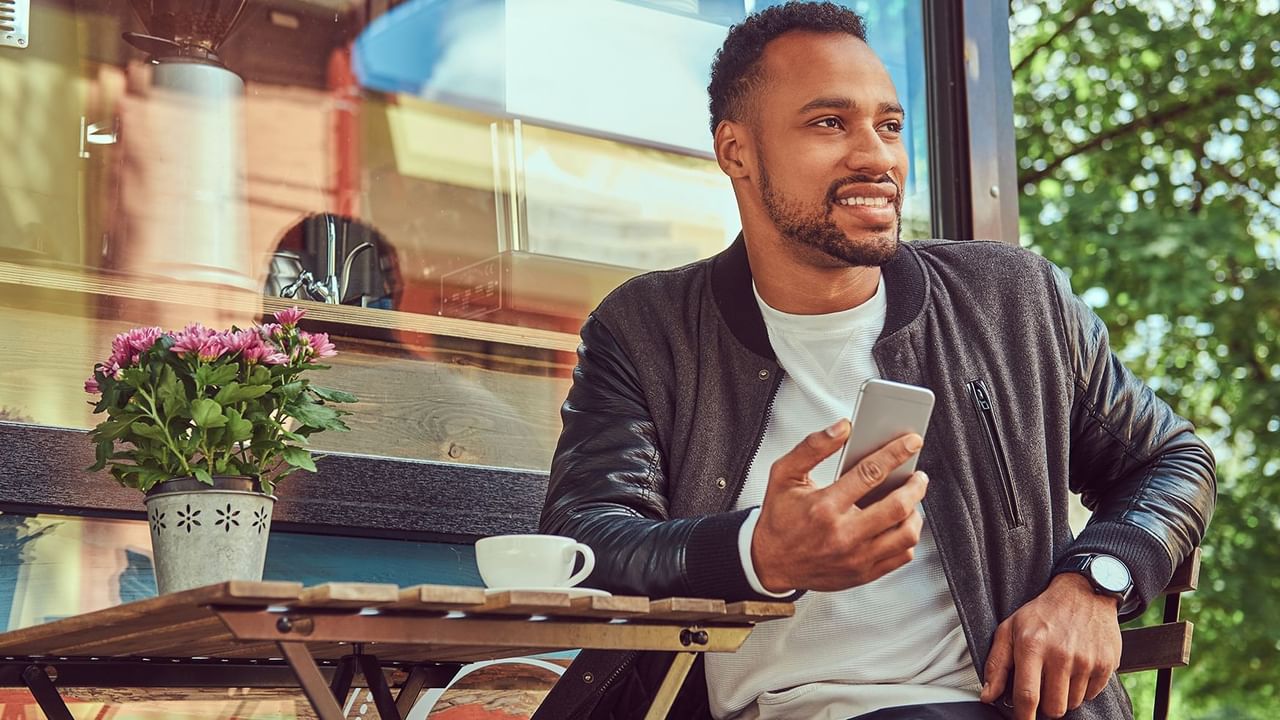 man sitting on holding a phone