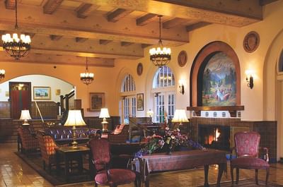 Main lobby lounge area with a fireplace, plush seating, and warm lighting at Hassayampa Inn
