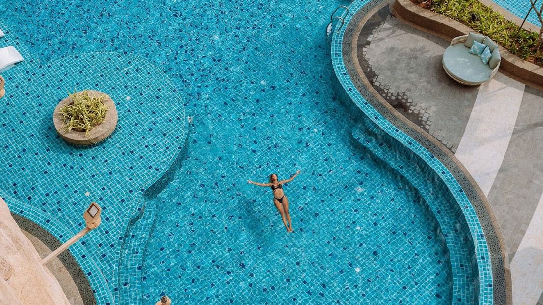 A lady floating in the swimming pool at Sunway Resort