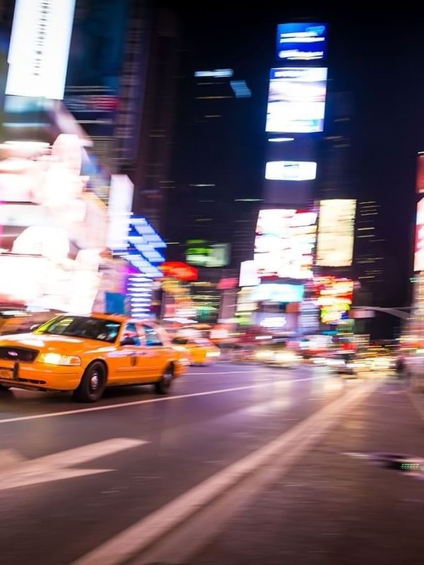 Taxi cab with glowing lights driving at Time Square near Warwick New York