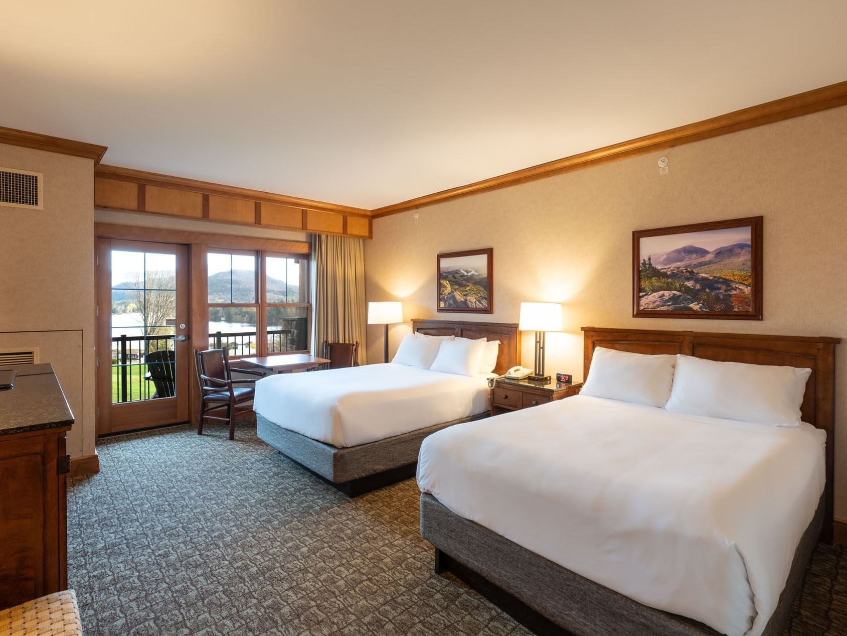 Double Queen Room at the Lake Placid Club Grandview, featuring two queen beds and a glass door leading to a private balcony