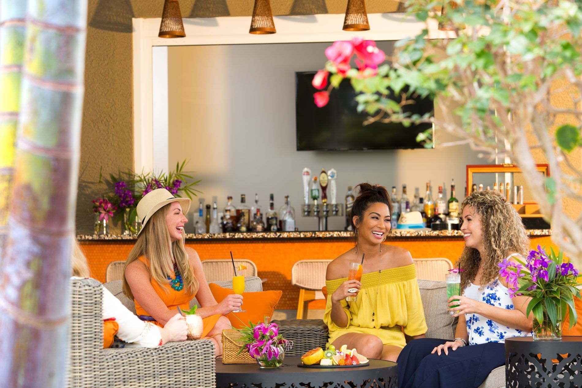 Girls sitting in The Springs Bar & Grill with drinks in Surfari Water Park at The Grove Resort & Water Park
