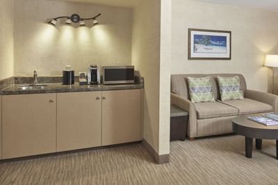 Equipped kitchenette with cozy loungers in One Bedroom Mountain View Suite at Waikiki Resort Hotel by Sono