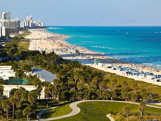 aerial shot of beach with city in background