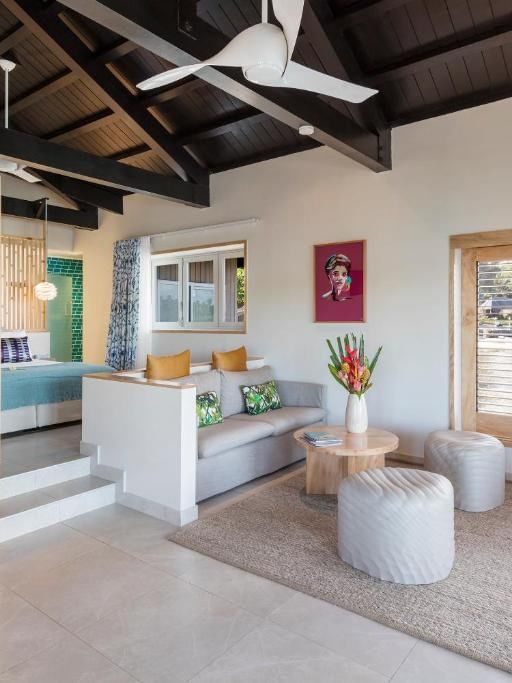 Stylish Overwater Villa living space with modern furnishings and wooden accents at Warwick Le Lagon - Vanuatu, Efate.