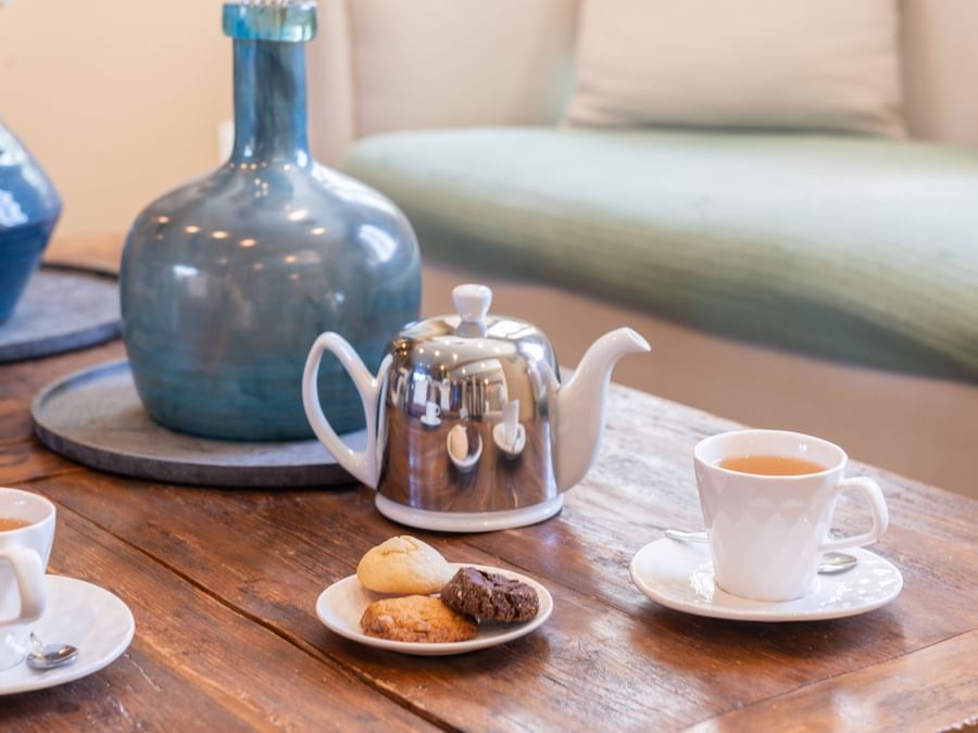Tea & cookies served on table in a room at The Originals Hotels