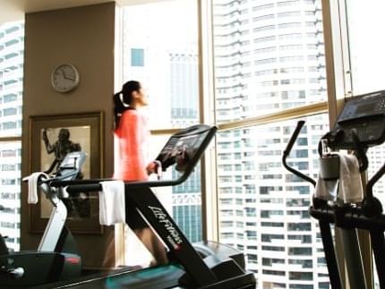 Lady running on the treadmill at The Sebel Quay West Suites Sydney
