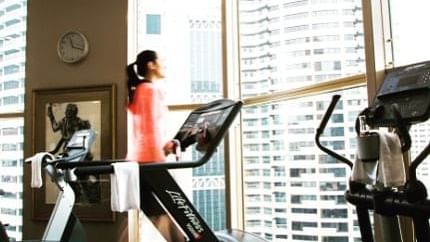 Lady running on the treadmill at The Sebel Quay West Suites Sydney