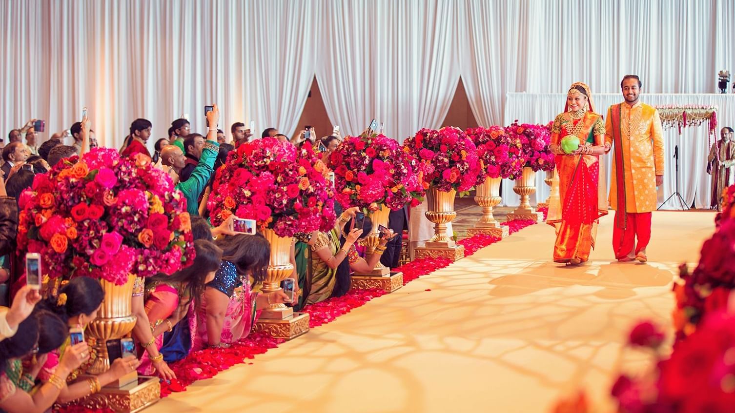 Indian wedding ceremony with bride & groom walking down the aisle at The Diplomat Resort