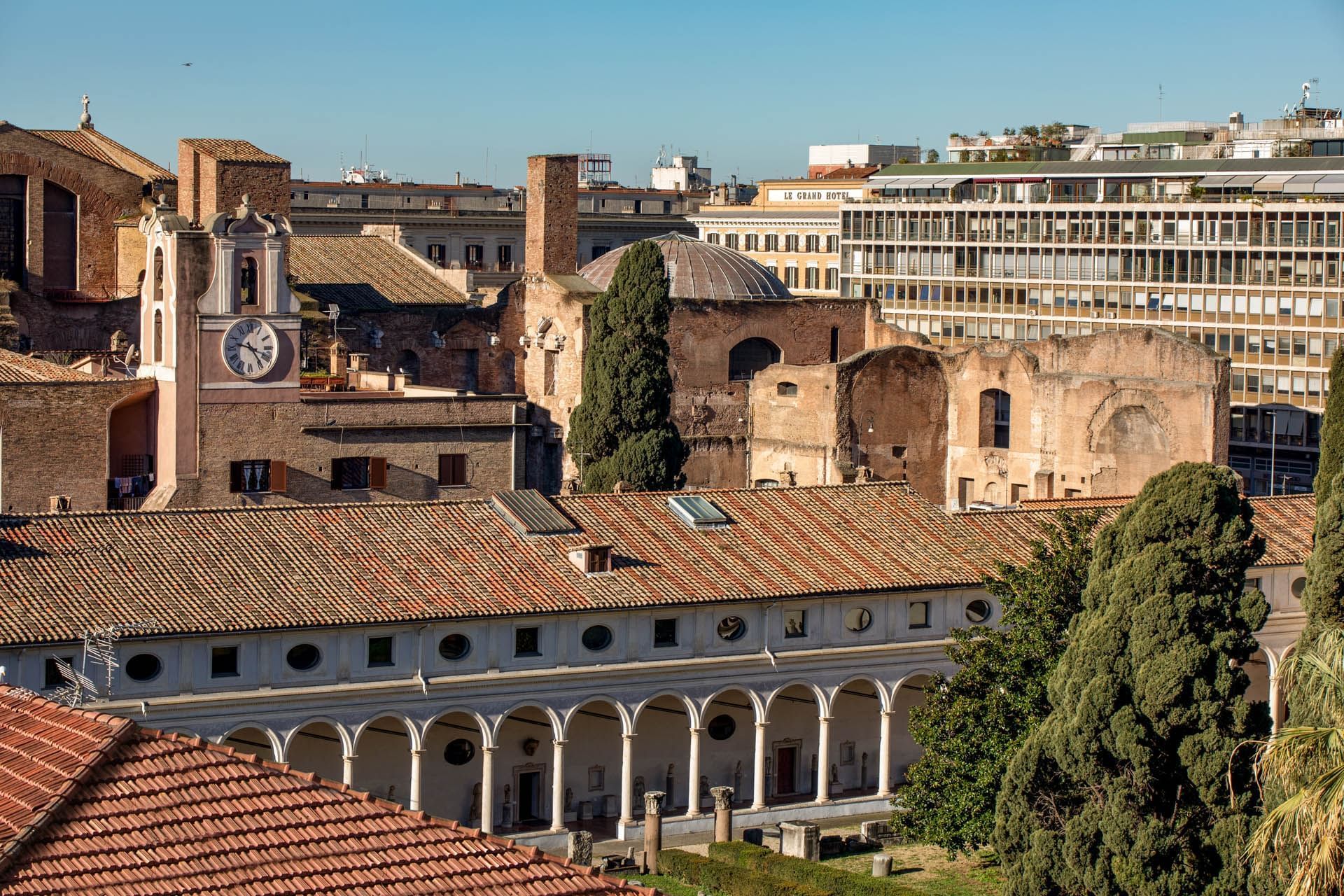 Skyline view of historic buildings with clock tower contrasting modern architecture in background near The Republic Hotel