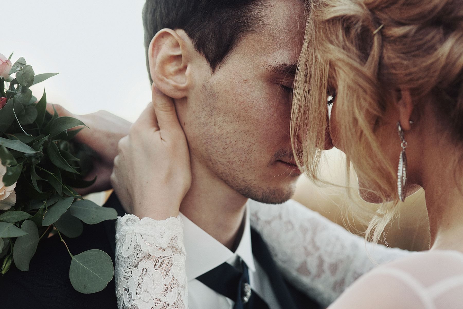 Newlyweds embracing each other intimately.