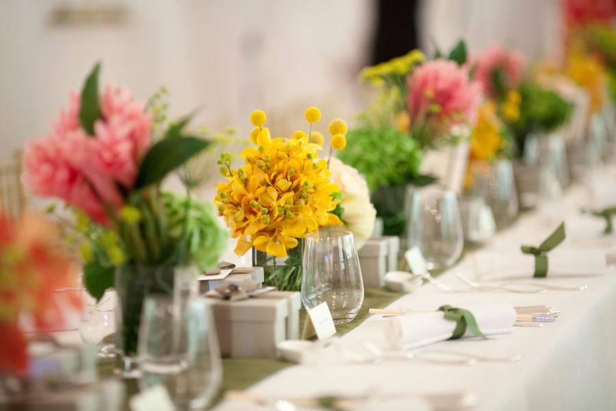 Table arranged with flower vases for an event at The Fullerton Hotel Singapore