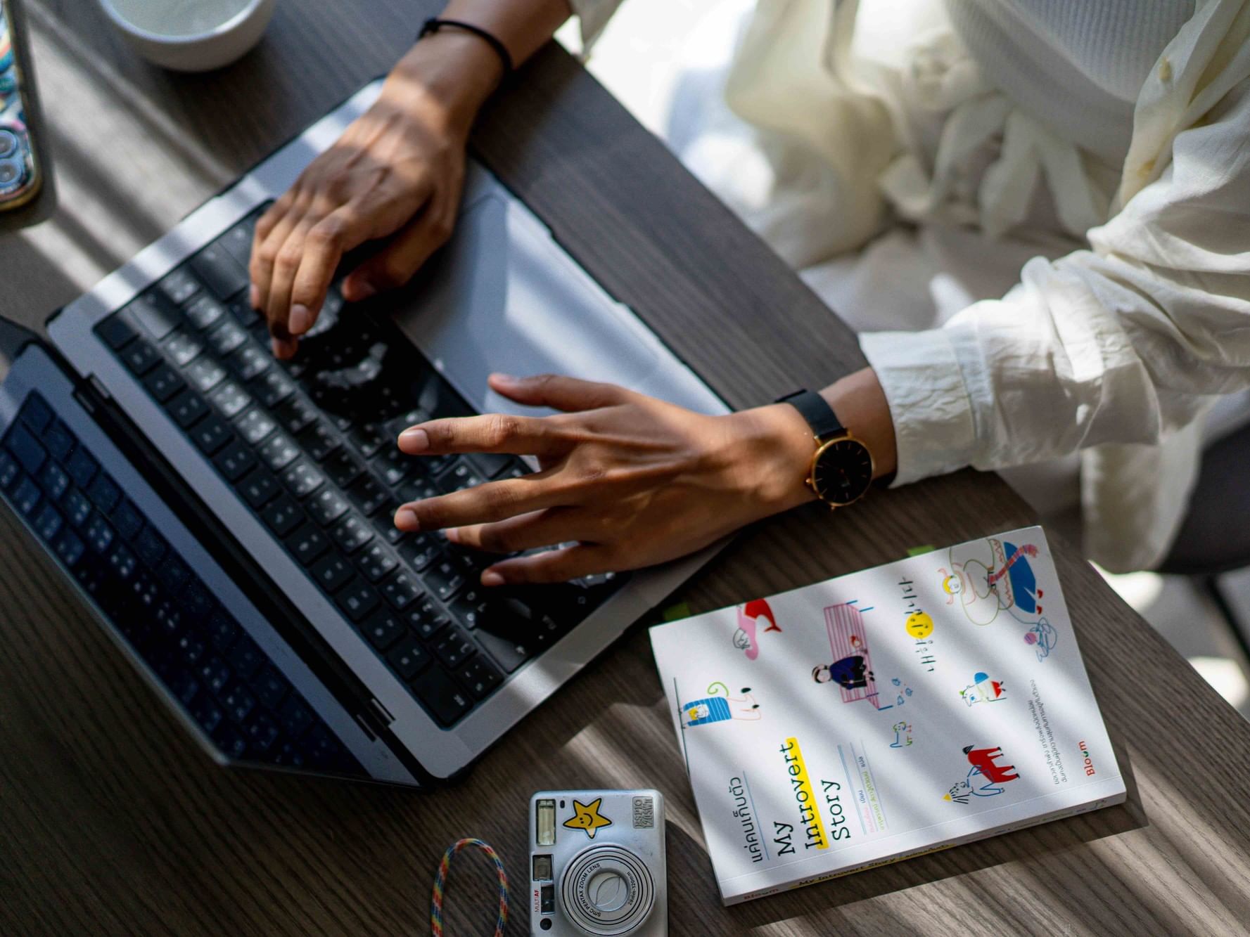 Digital nomad working remotely on a laptop in a Phuket hotel room with high-speed Wi-Fi, ideal for a workation stay in Karon Beach.