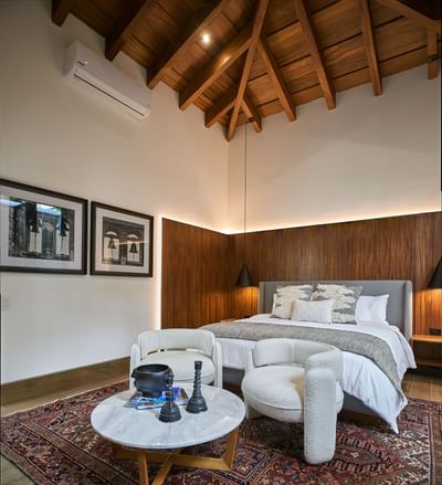 Luxurious bedroom with a high vaulted ceiling and a wooden headboard at Singular Signature Residences