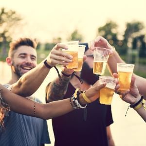 Friends toasting beer near Rosen Inn Universal