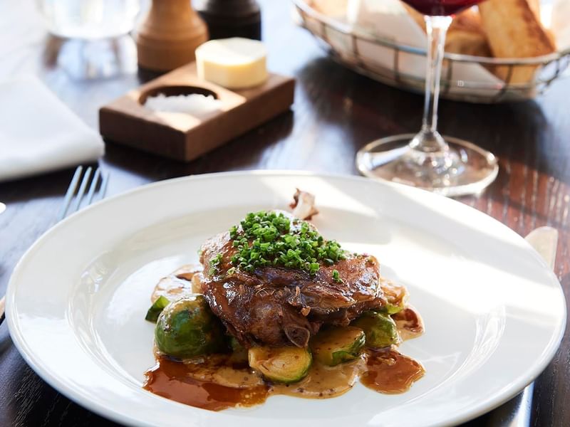 Gourmet meal of steak and Brussels sprouts served in Bistro Guillaume at Crown Hotel Melbourne