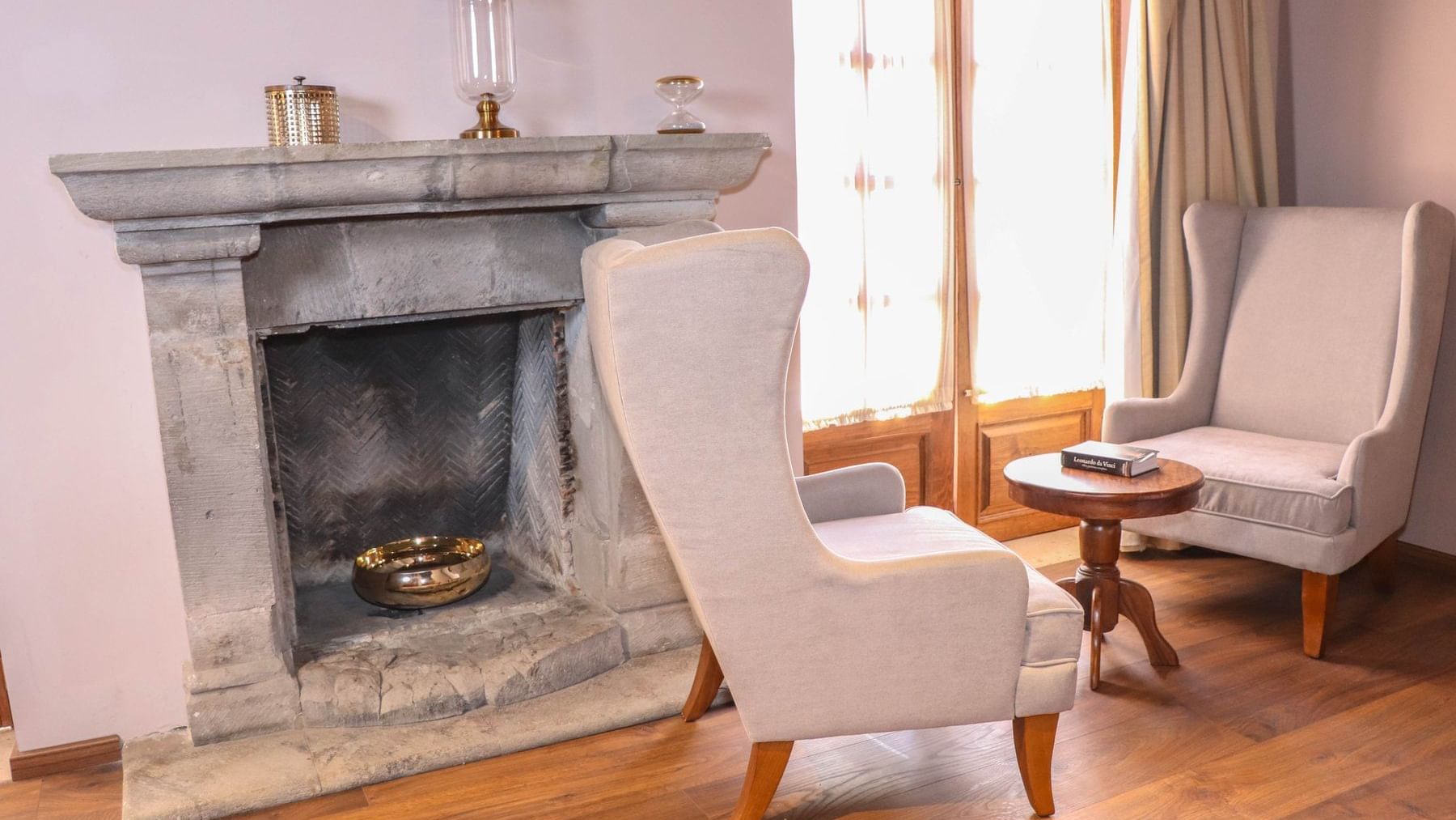 A fireplace by a lounge area in Junior Suite at Gamma Hotels