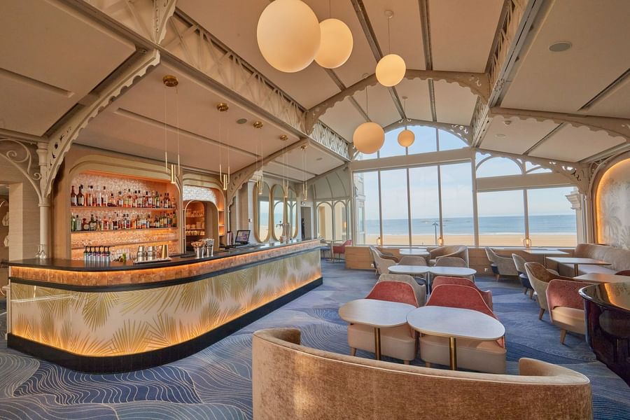 La Passerelle bar offers stylish seating and large windows overlooking the sea at Le Grand Hôtel des Thermes