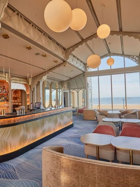 La Passerelle bar offers stylish seating and large windows overlooking the sea at Le Grand Hôtel des Thermes