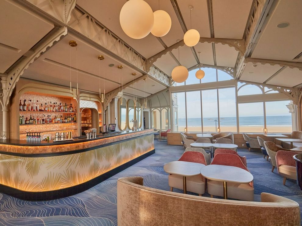 La Passerelle bar offers stylish seating and large windows overlooking the sea at Le Grand Hôtel des Thermes