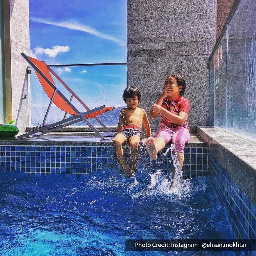 Two kids were having fun by the private pool at Lexis Suites Penang hotel - Lexis Suites Penang