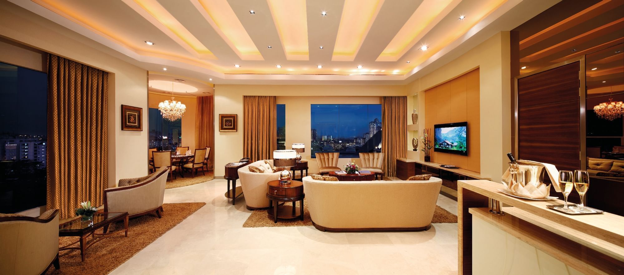 The living area of a suite with sofas & a TV at Sunway Hotel