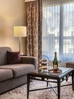 Grey sofa by an armchair surrounding a coffee table in  Executive Suite with Terrace at Warwick Paris Champs Elysées