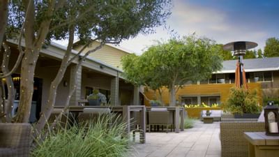 Outdoor lounge area with a fireplace at The Nest Palo Alto
