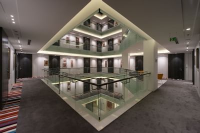 Staircase view from the second floor corridor at Eastin Residences Vadodara