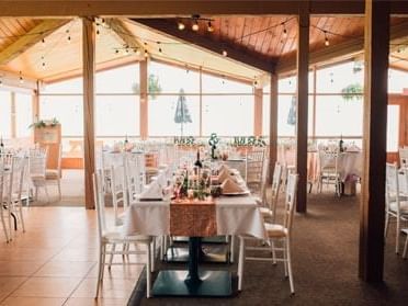 Wedding dining tables arranged in Mountainside Clubhouse at Fairmont Hot Springs Resort