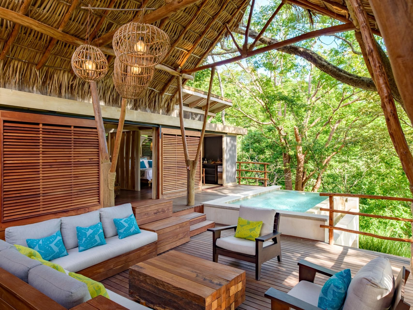 Two Bedroom Villas with Private Pool next to a thatched-roof bungalow at Morgan's Rock Reserve & Ecolodge