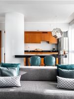 Penthouse Crescent living area with a sofa by a kitchen island with stools at Warwick Le Crystal Montreal