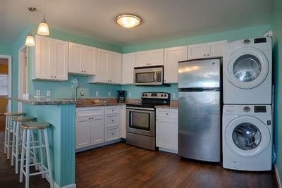 Kitchen with washer and dryer in 3 Bedroom Apartment - 5 Queen Beds at South Beach Apartments Ocean City MD