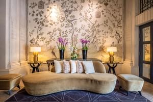 Lobby lounge area with cozy sofa & floral arrangement at Hotel Barsey by Warwick - Brussels