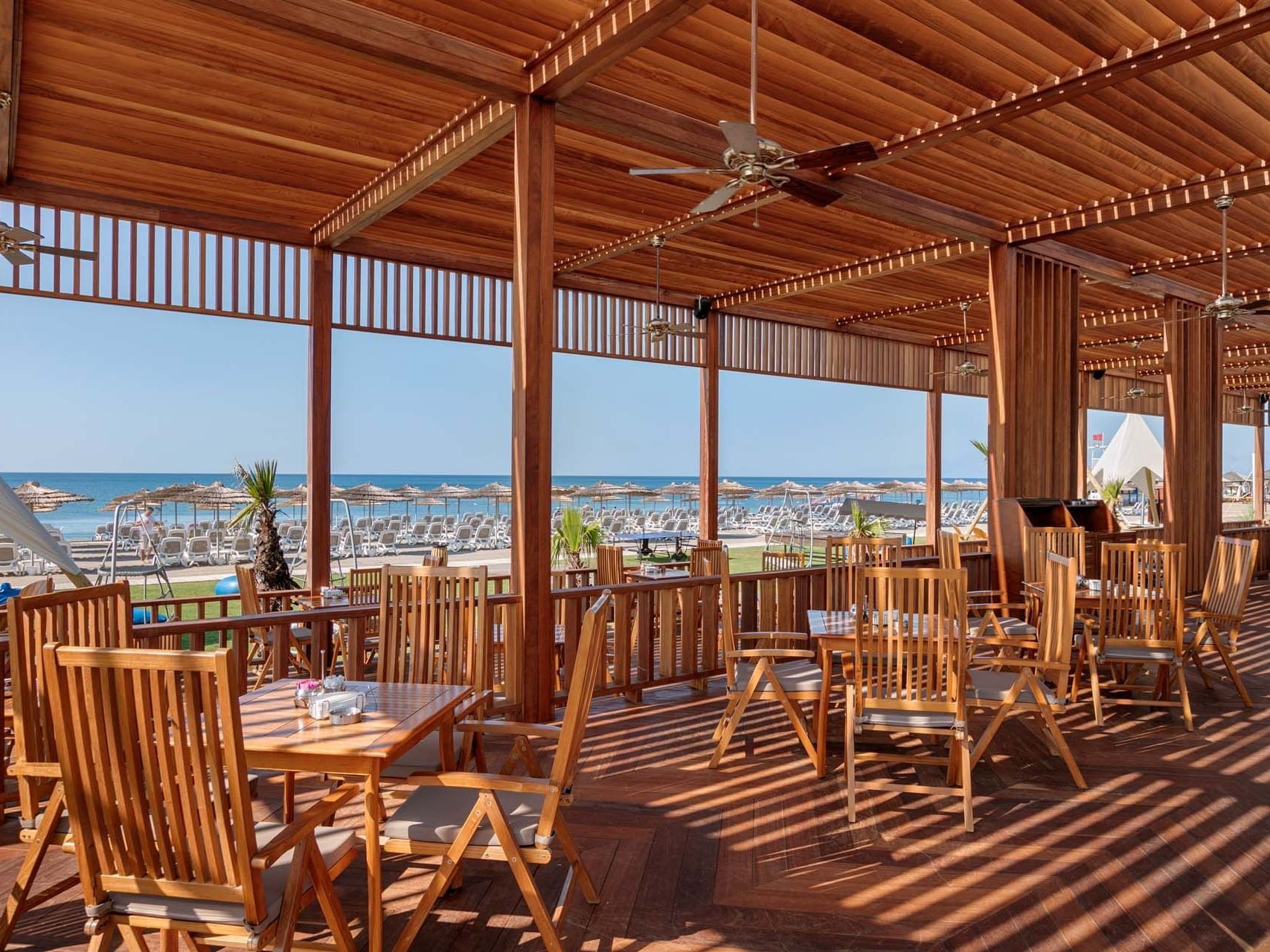 Wooden finished dining area well arranged with sea view in Palm Bar at Titanic Deluxe Golf Belek