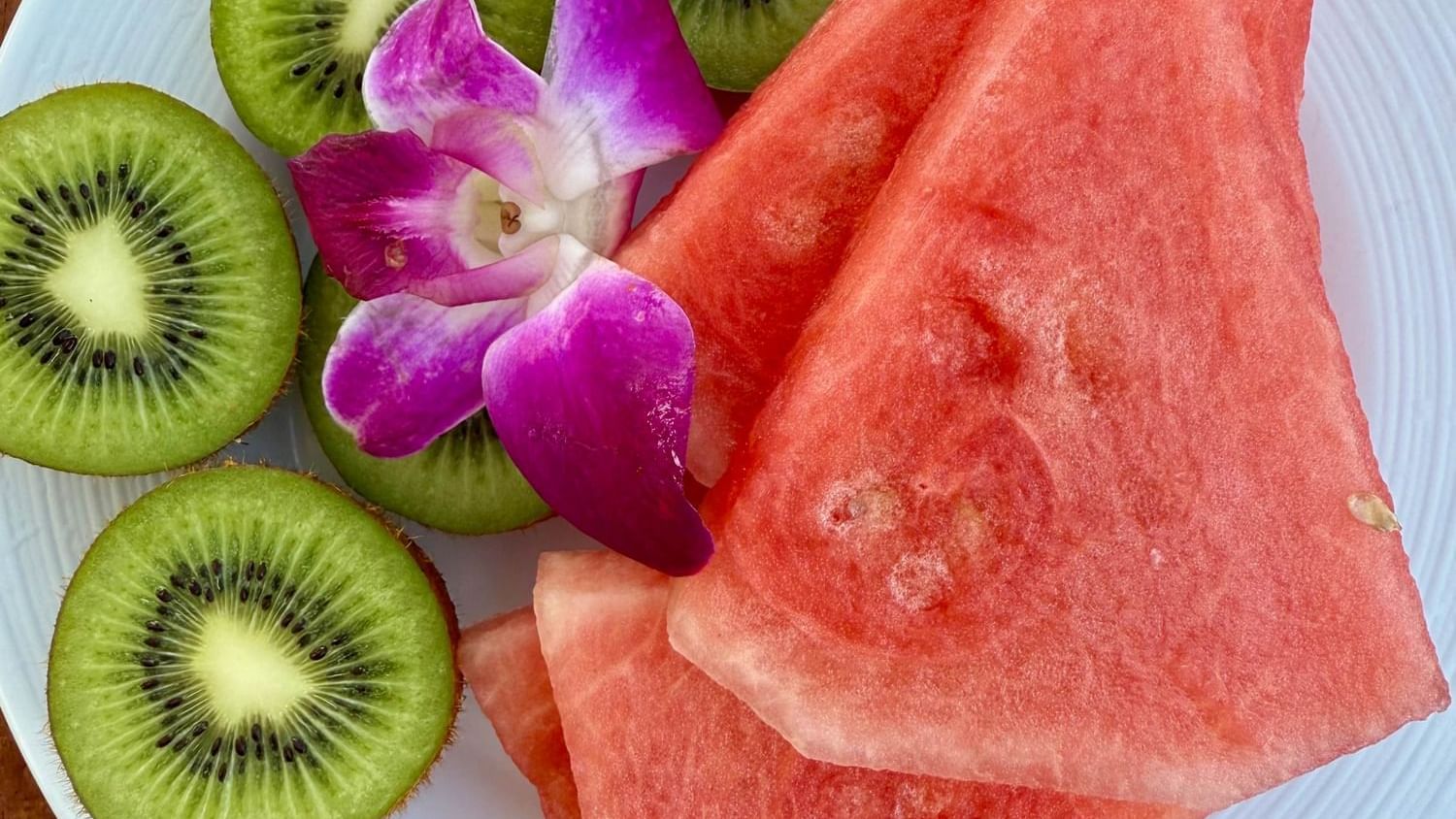 Watermelon and kiwi slices with a flower on a plate at Warwick Paradise Island - Bahamas in Nassau.