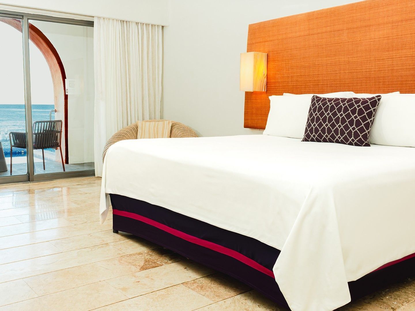 Cozy lounge chair and private balcony with an ocean view in King Camino Real Club at Camino Real Zaashila Huatulco