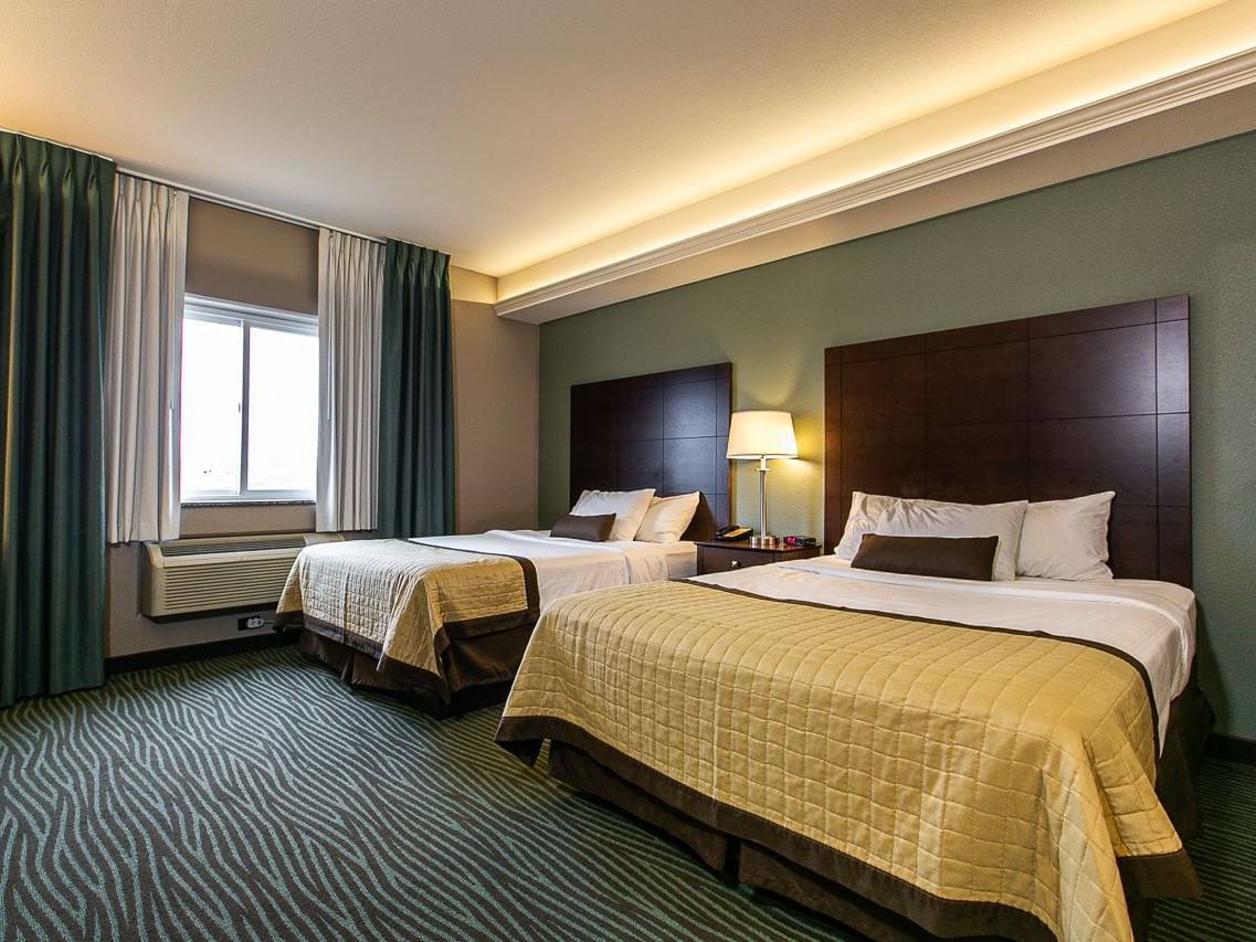 Cozy beds and carpeted floor in Queen Resort View at Off Shore Resort
