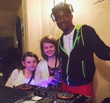 Two girls posing with DJ Snoopy at The Somerset On Grace Bay