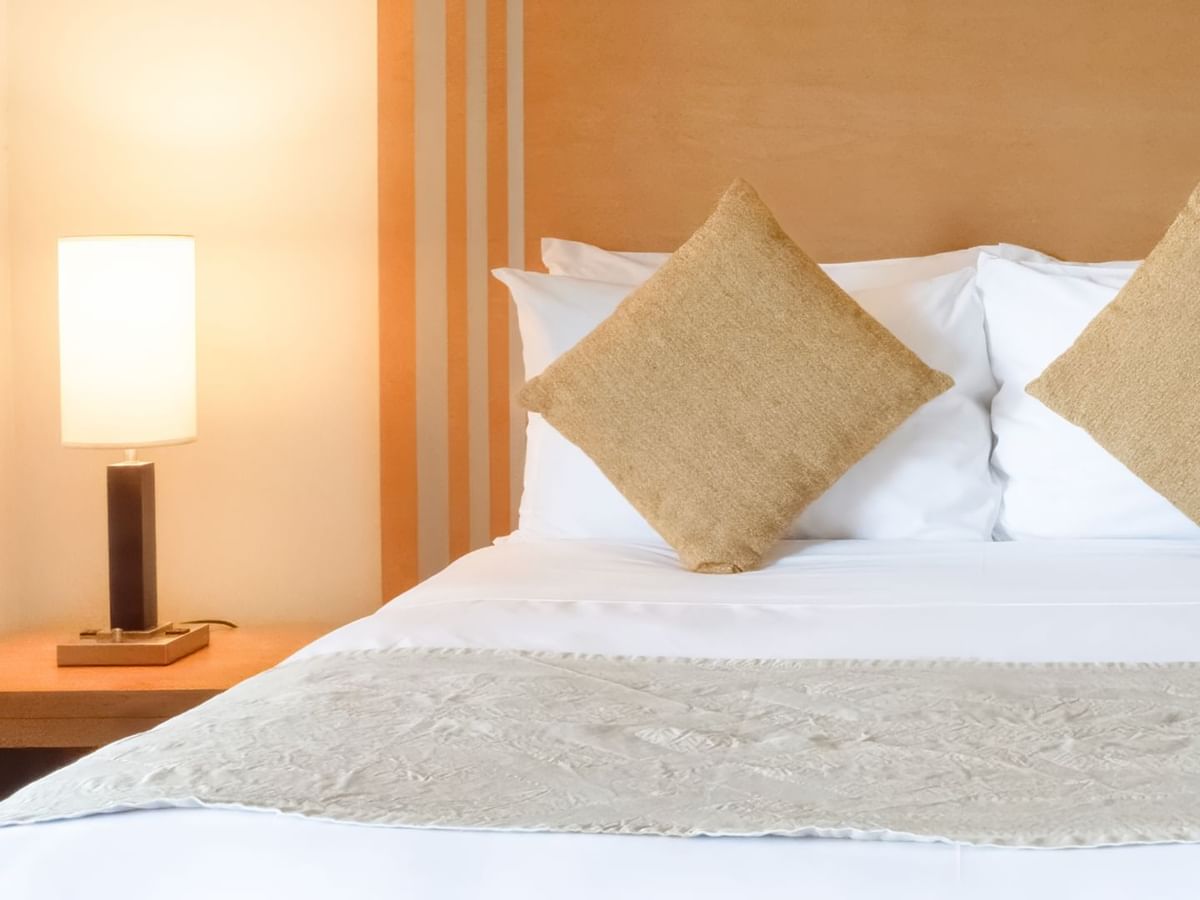 Bed with lamp and cushions