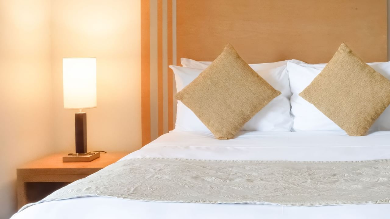 Bed with lamp and cushions