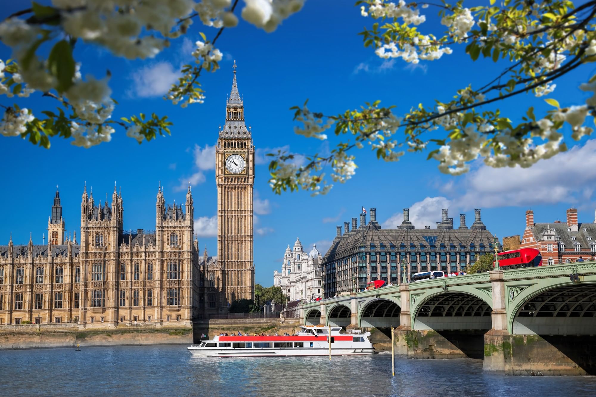 Big Ben, Houses of Parliament, and a bridge with a red double-decker bus at Warwick Corporate