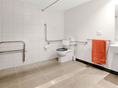 Accessible bathroom with toilet, sink, and shower at La Trobe University - North and South Apartments.