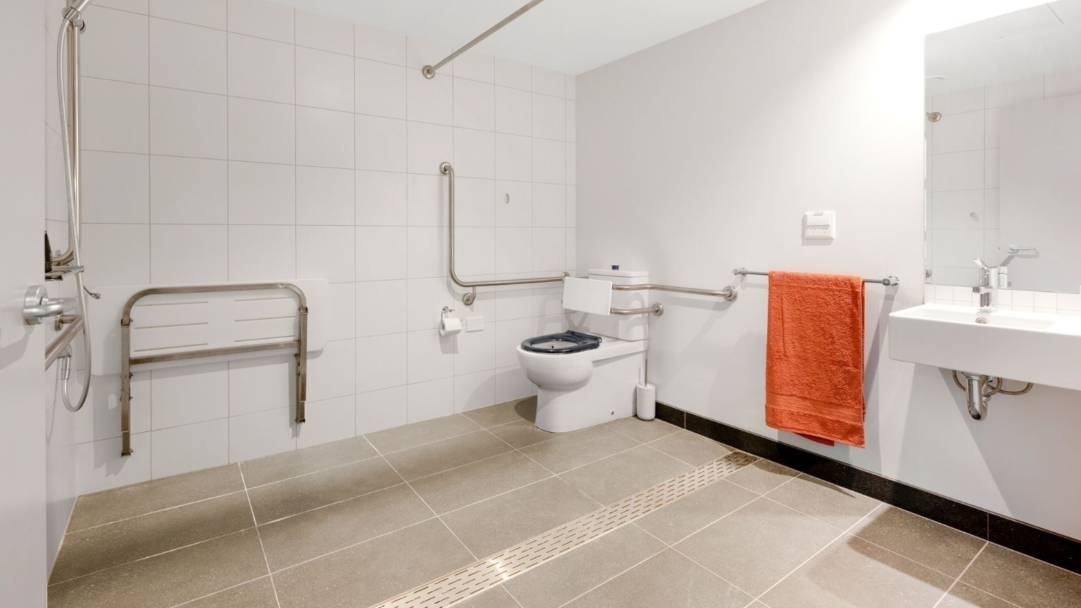 Accessible bathroom with toilet, sink, and shower at La Trobe University - North and South Apartments.
