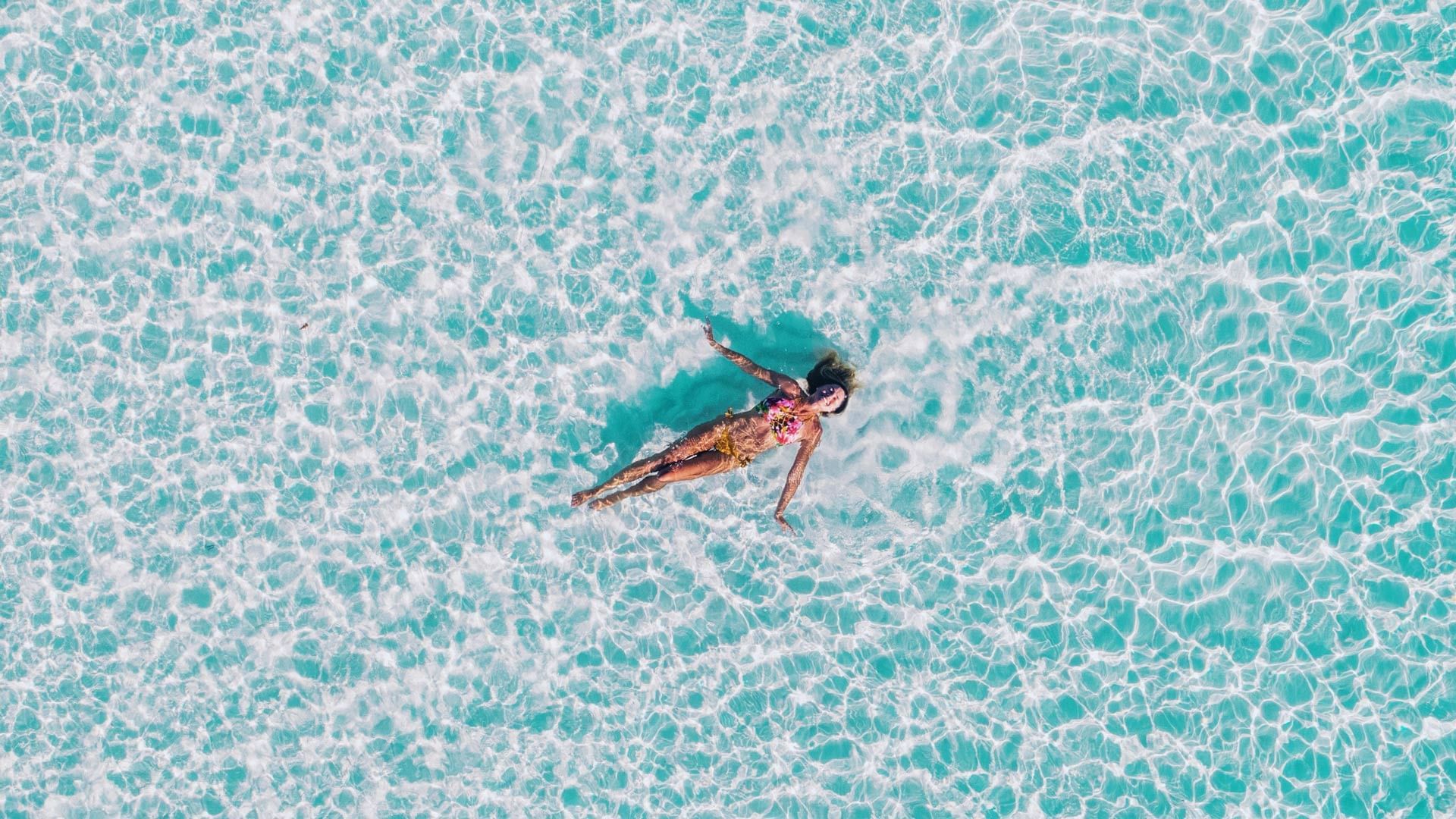 A Lady swimming in the pool in Novotel Cairns Oasis   